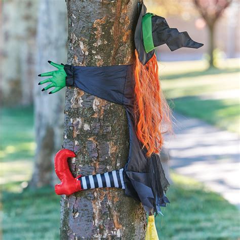 Witch crashing into a spooky tree halloween decoration